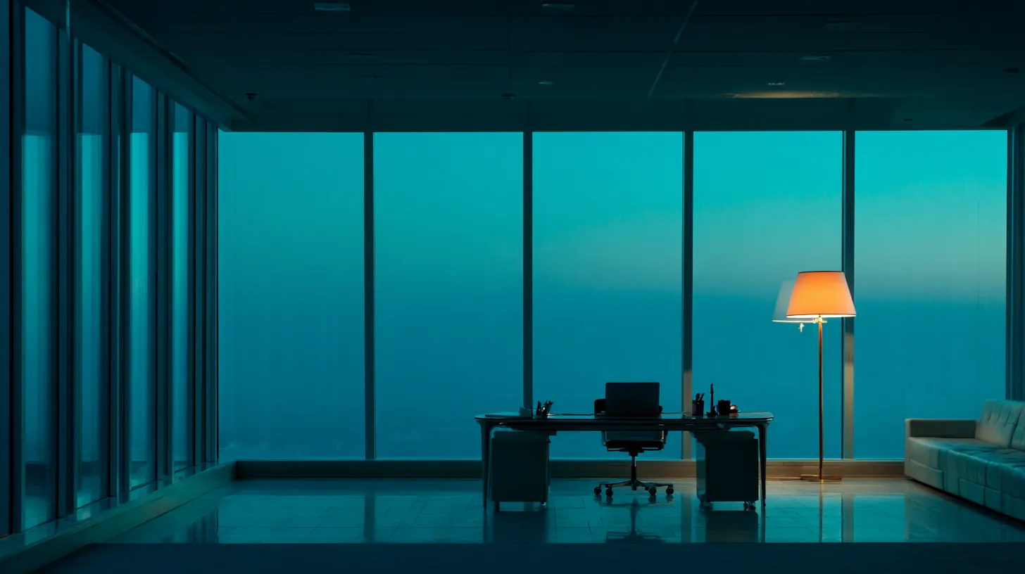 Quiet office at dusk, teal light and a single floor lamp